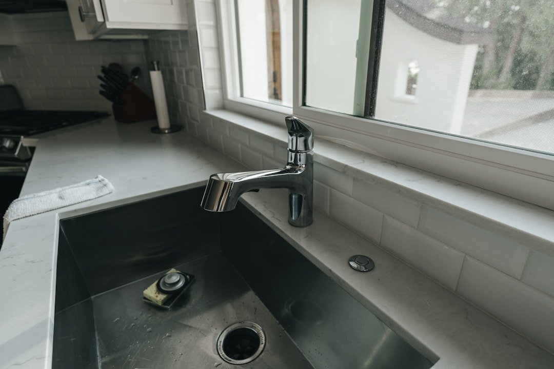 Kitchen sink P-trap and drain plumbing under the cabinet